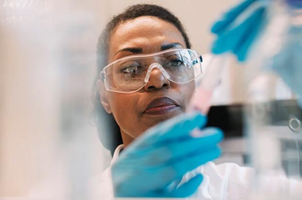 virologist wearing eyeglasses experimenting in laboratory